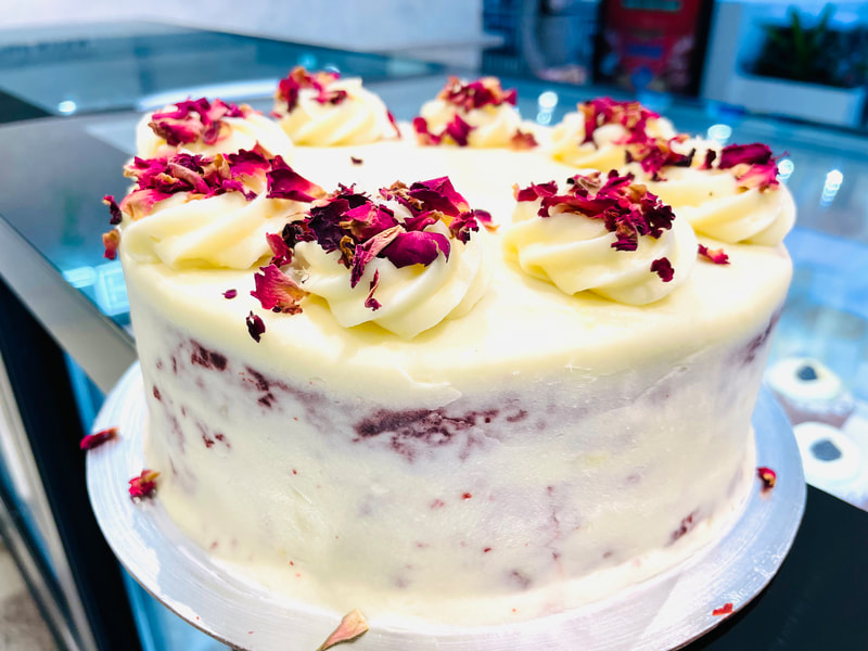 Light & moist red velvet cake covered with a delicious cream cheese icing and rose petals